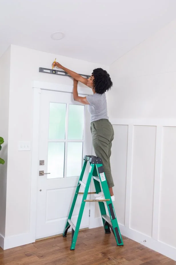 The next step in this DIY accent wall project is to draw the outline of the painted portion using a pencil and a level for straight lines.